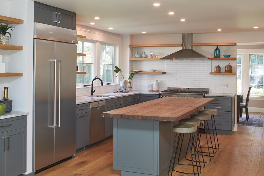 9 Saxon Road Newton, MA 02461 - Photo 5 of 11 a kitchen with stainless steel appliances granite countertop a kitchen island a stove and a refrigerator