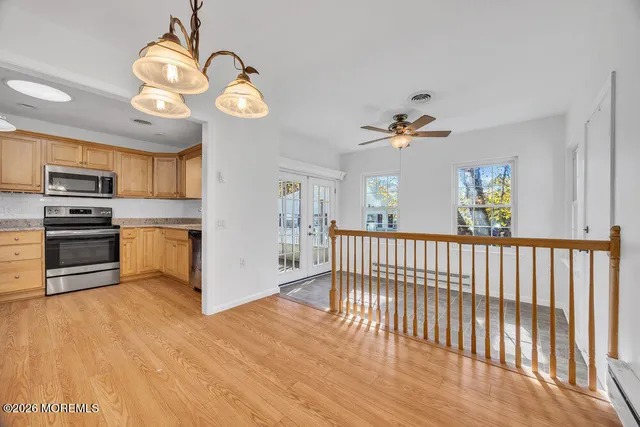 a view of a kitchen with a stove cabinets and a ceiling fan