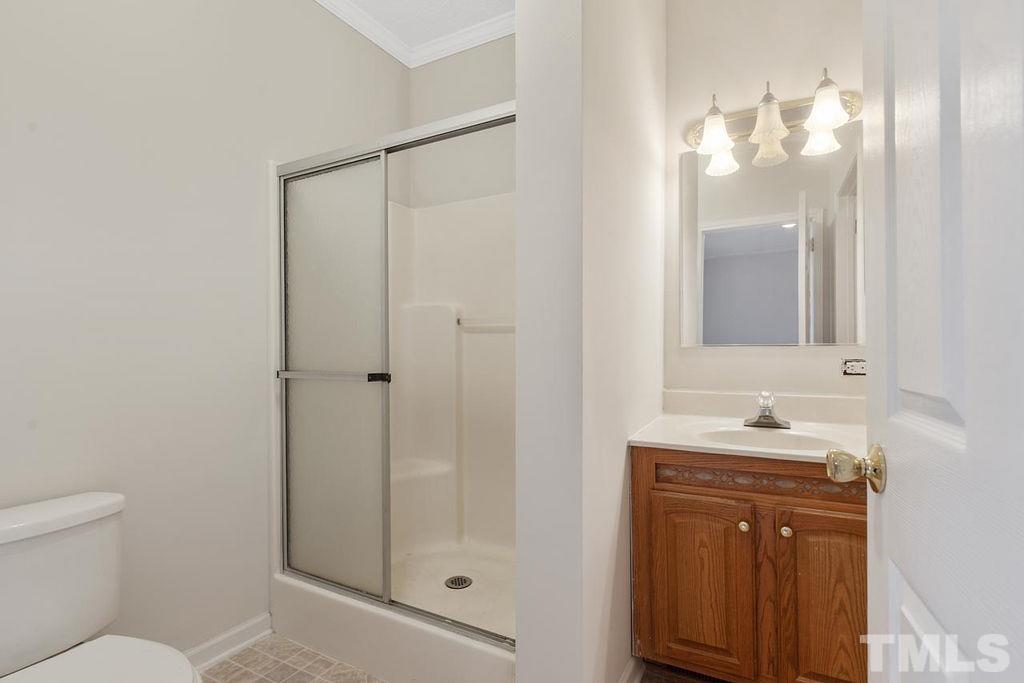 184 Brantleytown Road Zebulon, NC 27597 - Photo 14 of 26 a bathroom with a sink a toilet and shower