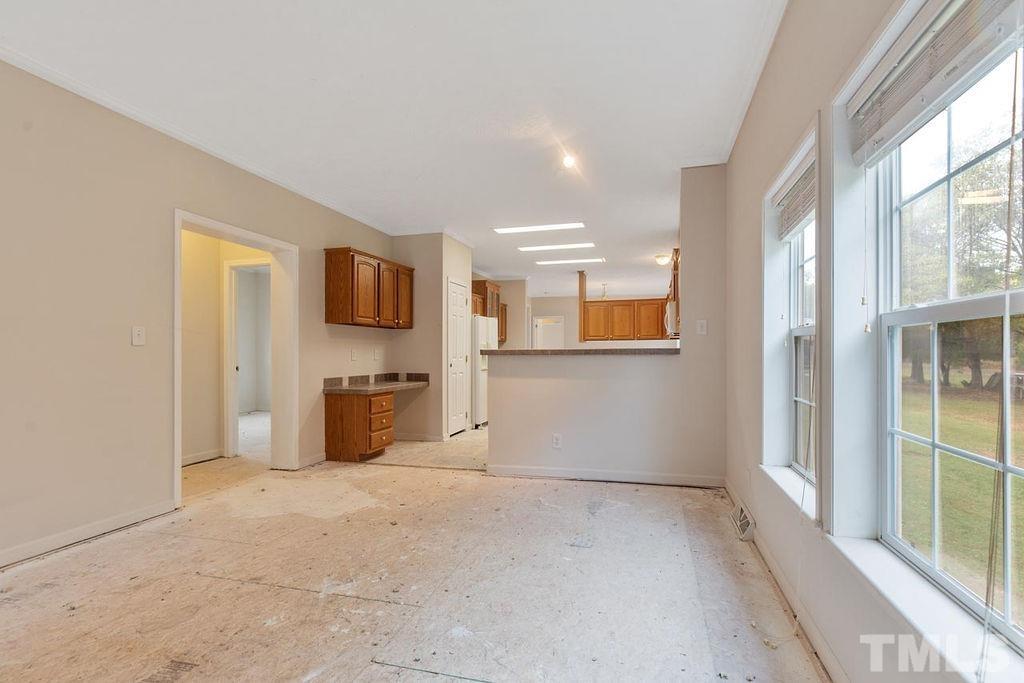 184 Brantleytown Road Zebulon, NC 27597 - Photo 22 of 26 a view of a kitchen with furniture and a flat screen tv