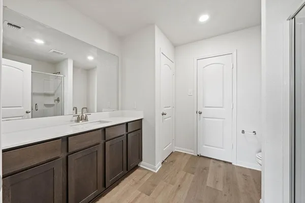 a bathroom with a double vanity sink and a mirror
