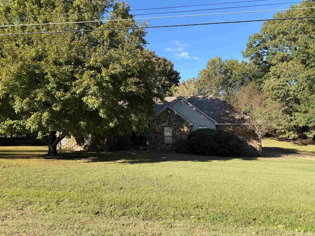 a view of yard with swimming pool and green space