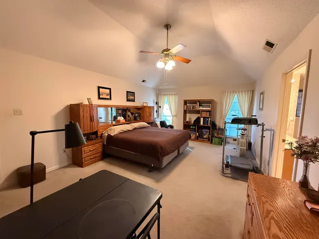 a bedroom with furniture and a chandelier