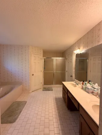 a bathroom with a tub sink and mirror
