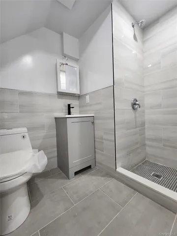 a bathroom with a toilet sink and shower