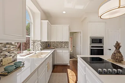 a kitchen with a sink stove and refrigerator
