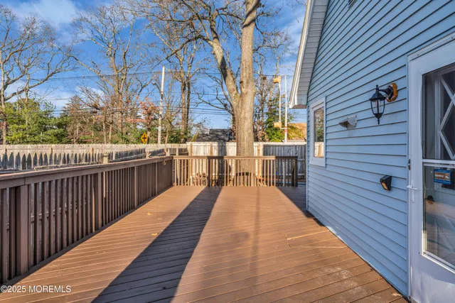 a view of balcony with wooden floor and fence