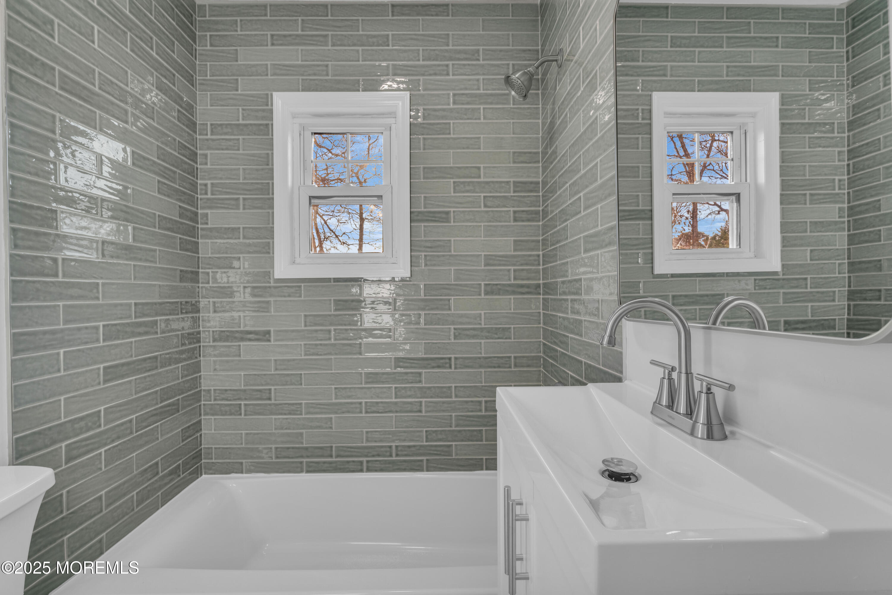 679 Mantoloking Road Brick, NJ 08723 - Photo 15 of 16 a bathroom with a sink and a bathtub