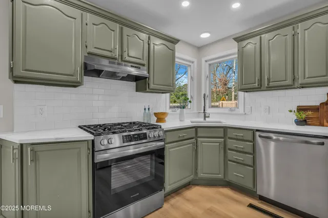 a kitchen with cabinets appliances and a window