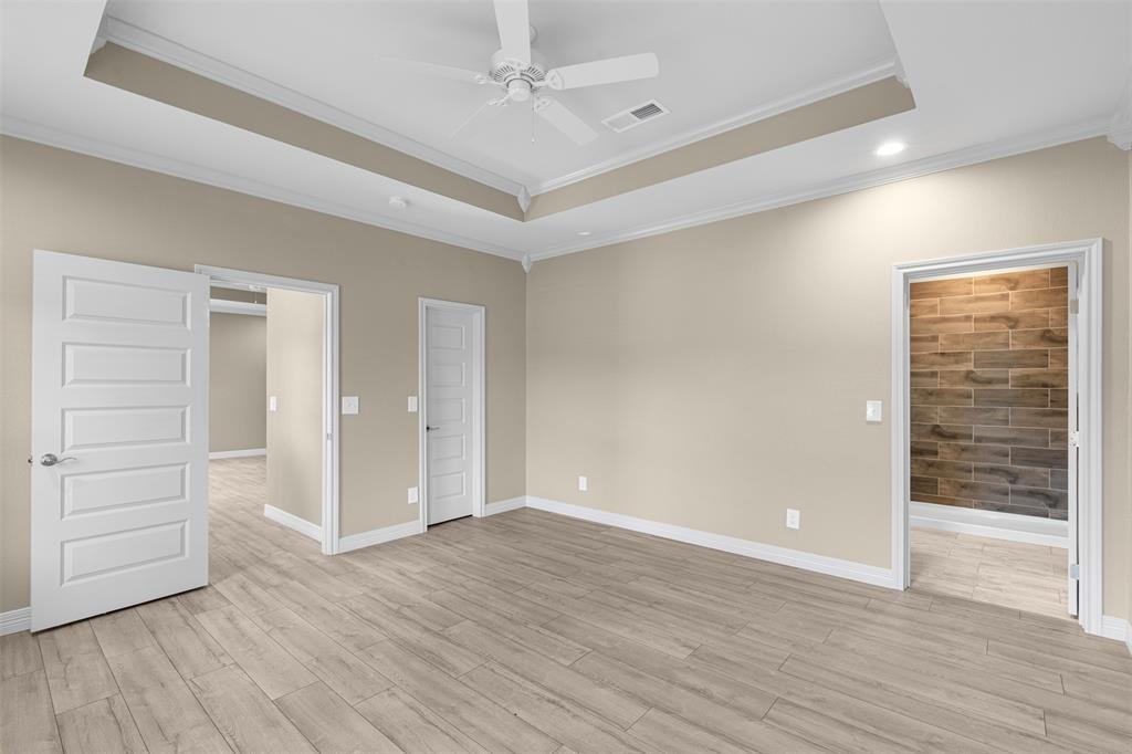 1011 Southeast County Road Corsicana, TX 75109 - Photo 16 of 40 an empty room with wooden floor closet and windows