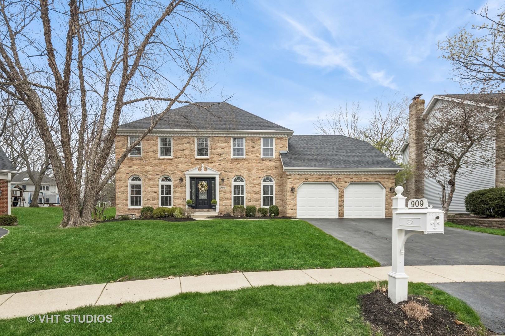 909 Lehigh Circle Naperville, IL 60565 - Photo 1 of 1 a front view of a house with a garden and trees