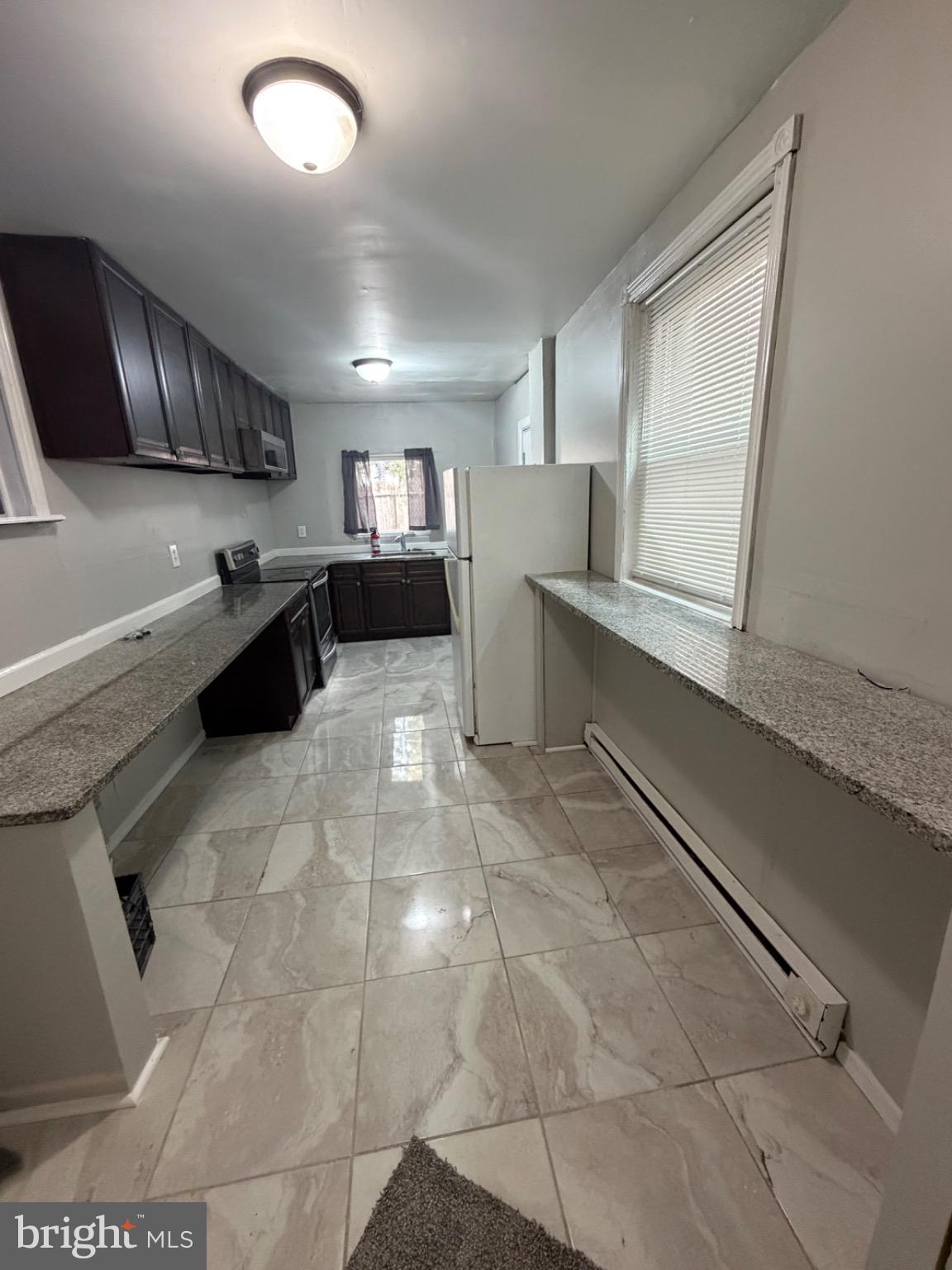 1609 Fillmore Street Philadelphia, PA 19124 - Photo 13 of 17 Modern kitchen with sleek granite counters.