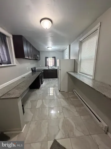 a kitchen with a stove and a refrigerator
