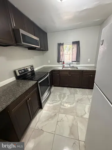 a kitchen with a stove and a refrigerator