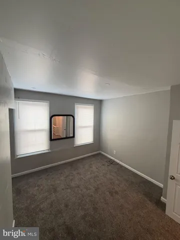an empty room with a window and a fireplace