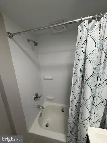 a bathroom with a bathtub and shower