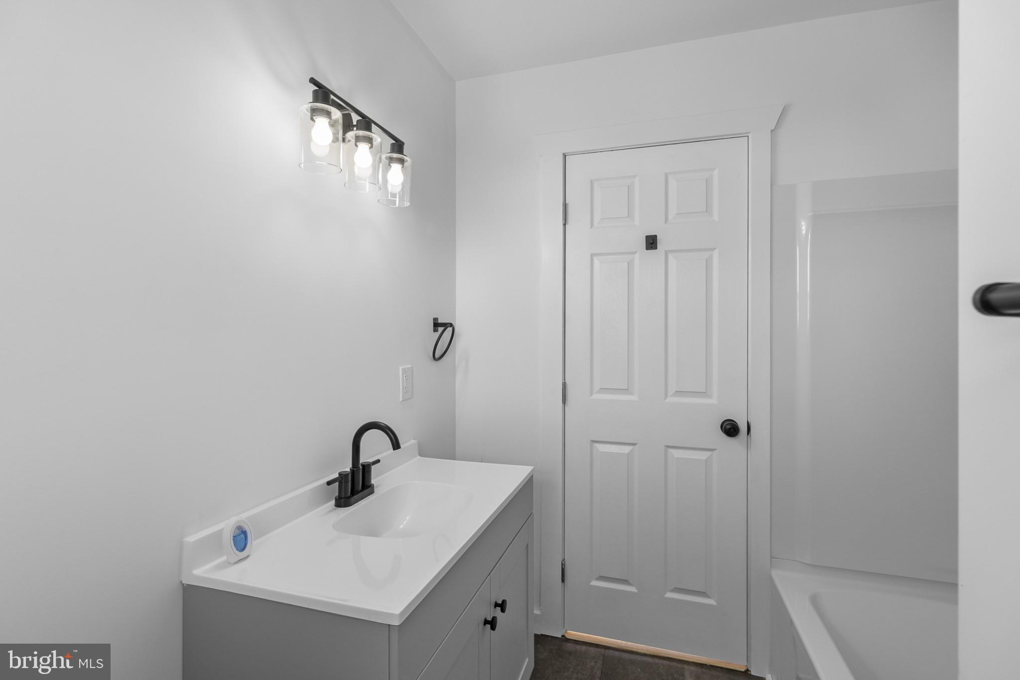 809 South Scott Street Middletown, DE 19709 - Photo 18 of 25 a bathroom with a sink a toilet and shower