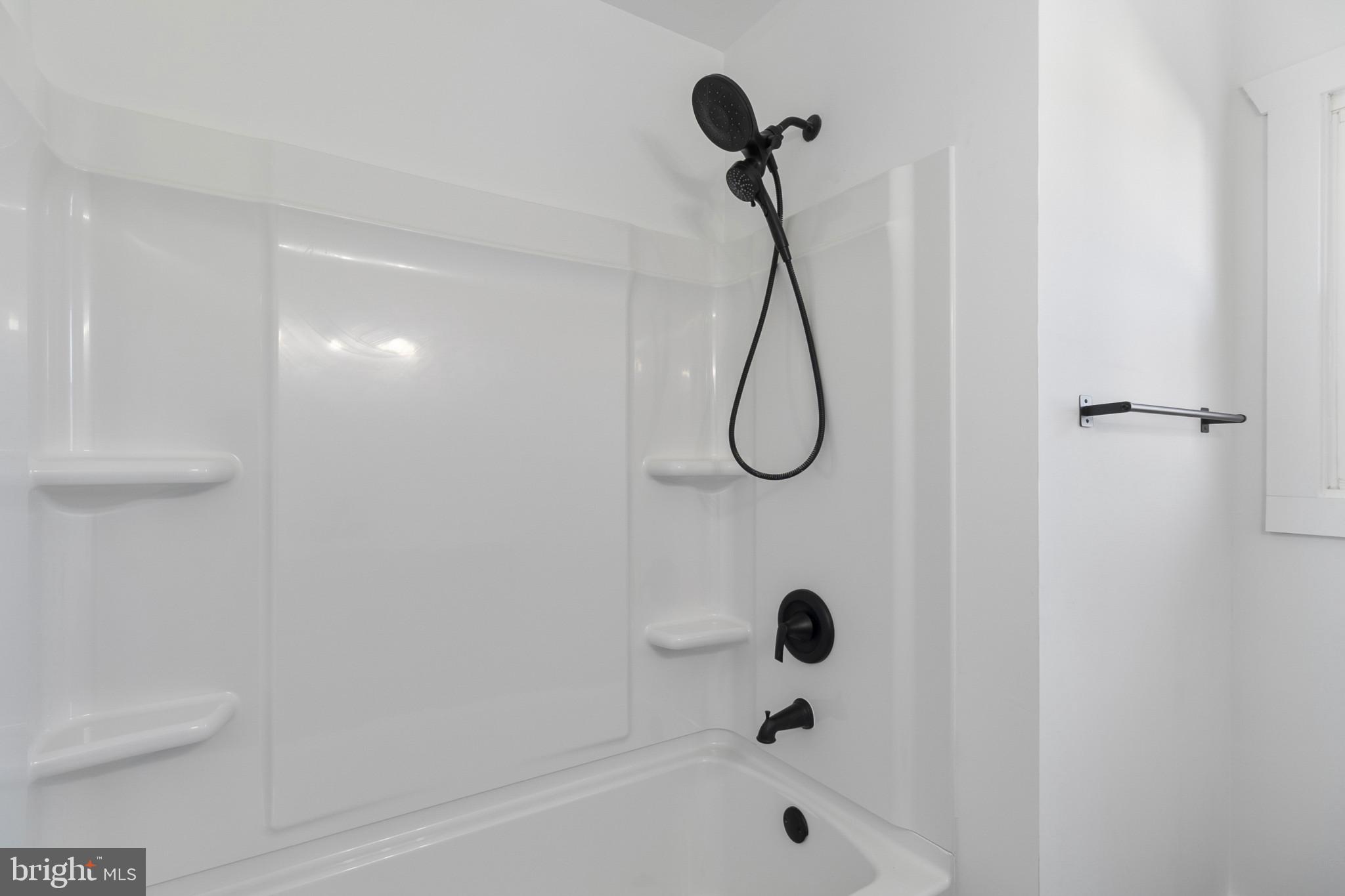 809 South Scott Street Middletown, DE 19709 - Photo 19 of 25 a bathroom with a bath tub and a shower