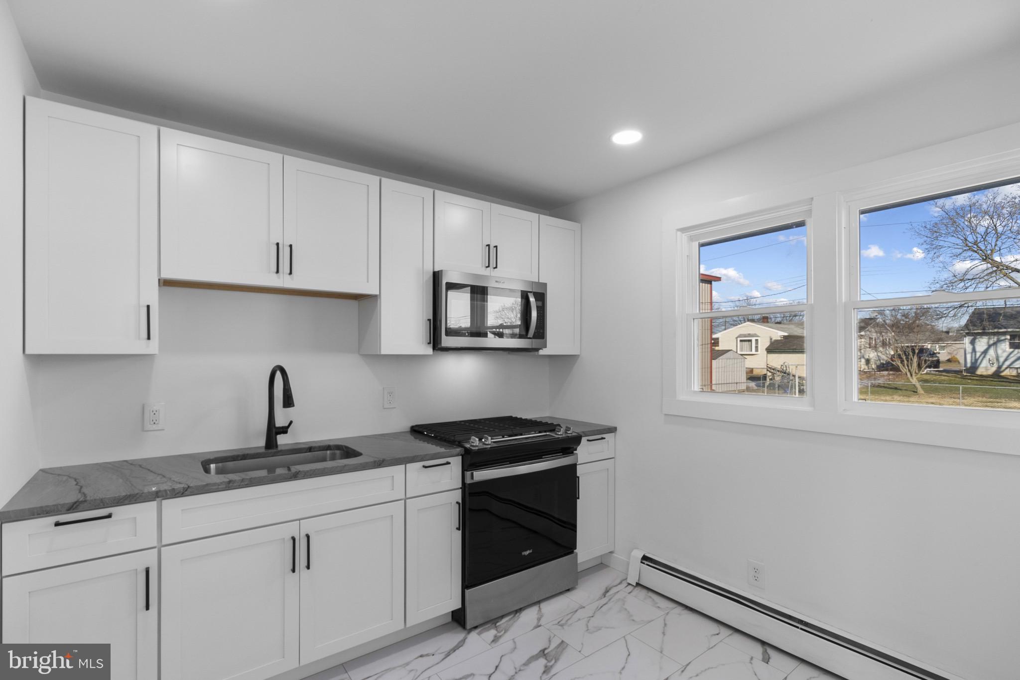 809 South Scott Street Middletown, DE 19709 - Photo 7 of 25 a kitchen with granite countertop a sink cabinets and stainless steel appliances