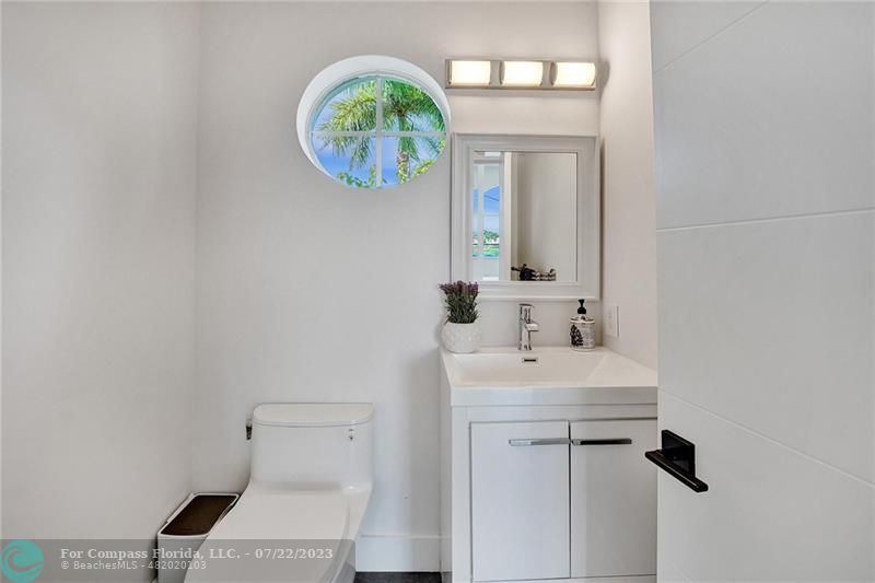 12355 Rockledge Circle Boca Raton, FL 33428 - Photo 16 of 38 a bathroom with a sink a vanity and a mirror
