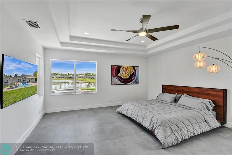 12355 Rockledge Circle Boca Raton, FL 33428 - Photo 17 of 38 a bedroom with a large bed and a window