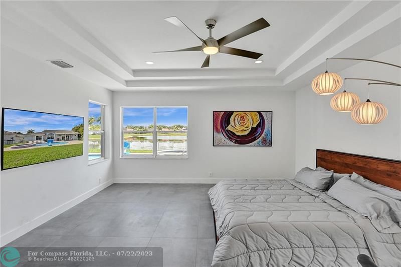 12355 Rockledge Circle Boca Raton, FL 33428 - Photo 18 of 38 a bedroom with a bed and a large window