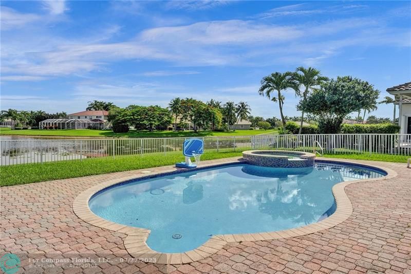 12355 Rockledge Circle Boca Raton, FL 33428 - Photo 29 of 38 a view of a swimming pool with a yard and sitting area