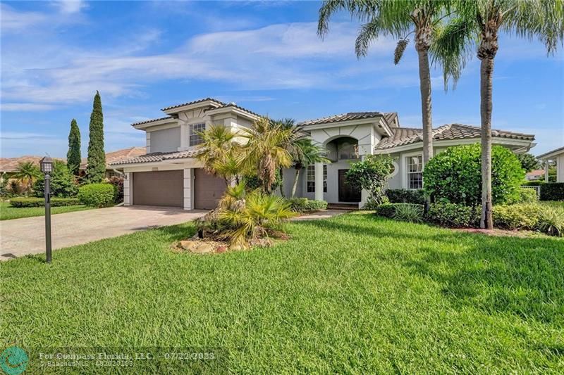 12355 Rockledge Circle Boca Raton, FL 33428 - Photo 37 of 38 a front view of a house with a garden and a yard