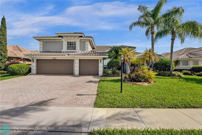 12355 Rockledge Circle Boca Raton, FL 33428 - Photo 38 of 38 a front view of a house with a yard and a garage