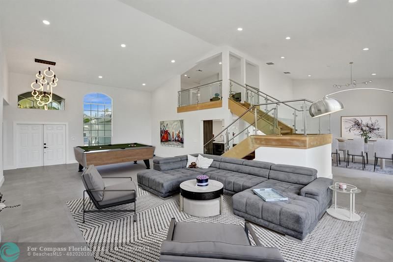 12355 Rockledge Circle Boca Raton, FL 33428 - Photo 5 of 38 a living room with furniture and a chandelier