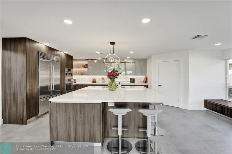 12355 Rockledge Circle Boca Raton, FL 33428 - Photo 7 of 38 a view of a kitchen with kitchen island a counter top space appliances and cabinets