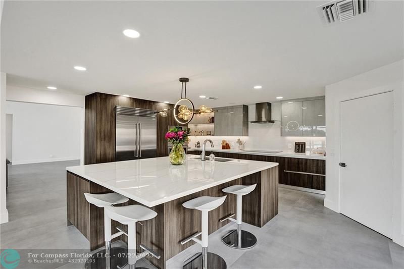 12355 Rockledge Circle Boca Raton, FL 33428 - Photo 8 of 38 a kitchen with kitchen island a sink stove and refrigerator