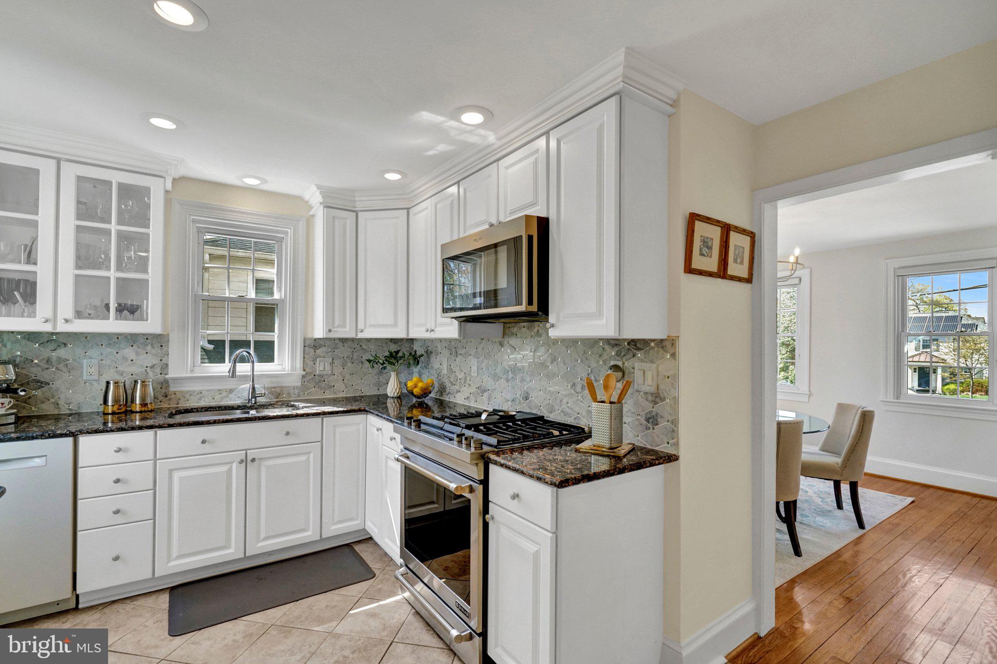 4916 26th Street North Arlington, VA 22207 - Photo 11 of 46 a kitchen with stainless steel appliances granite countertop a sink stove and cabinets