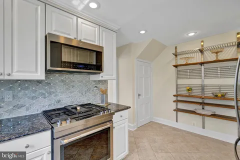 a kitchen with cabinets and a stove top oven