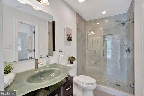 a bathroom with a sink toilet and shower