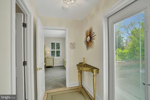 a view of a hallway with a shower and livingroom