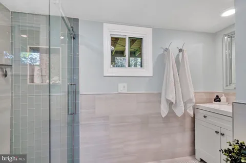 a bathroom with a bathtub sink and window