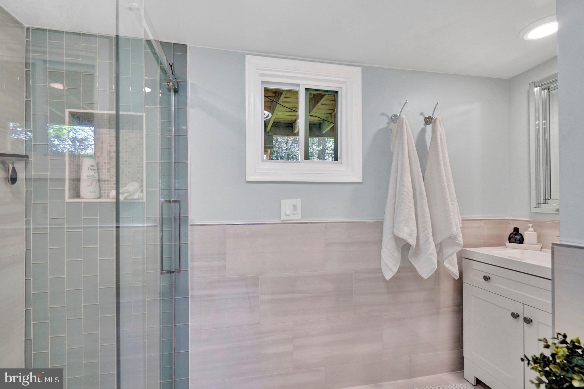 4916 26th Street North Arlington, VA 22207 - Photo 35 of 46 a bathroom with a bathtub sink and window