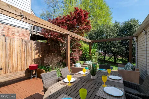a view of a patio with couches table and chairs and potted plants