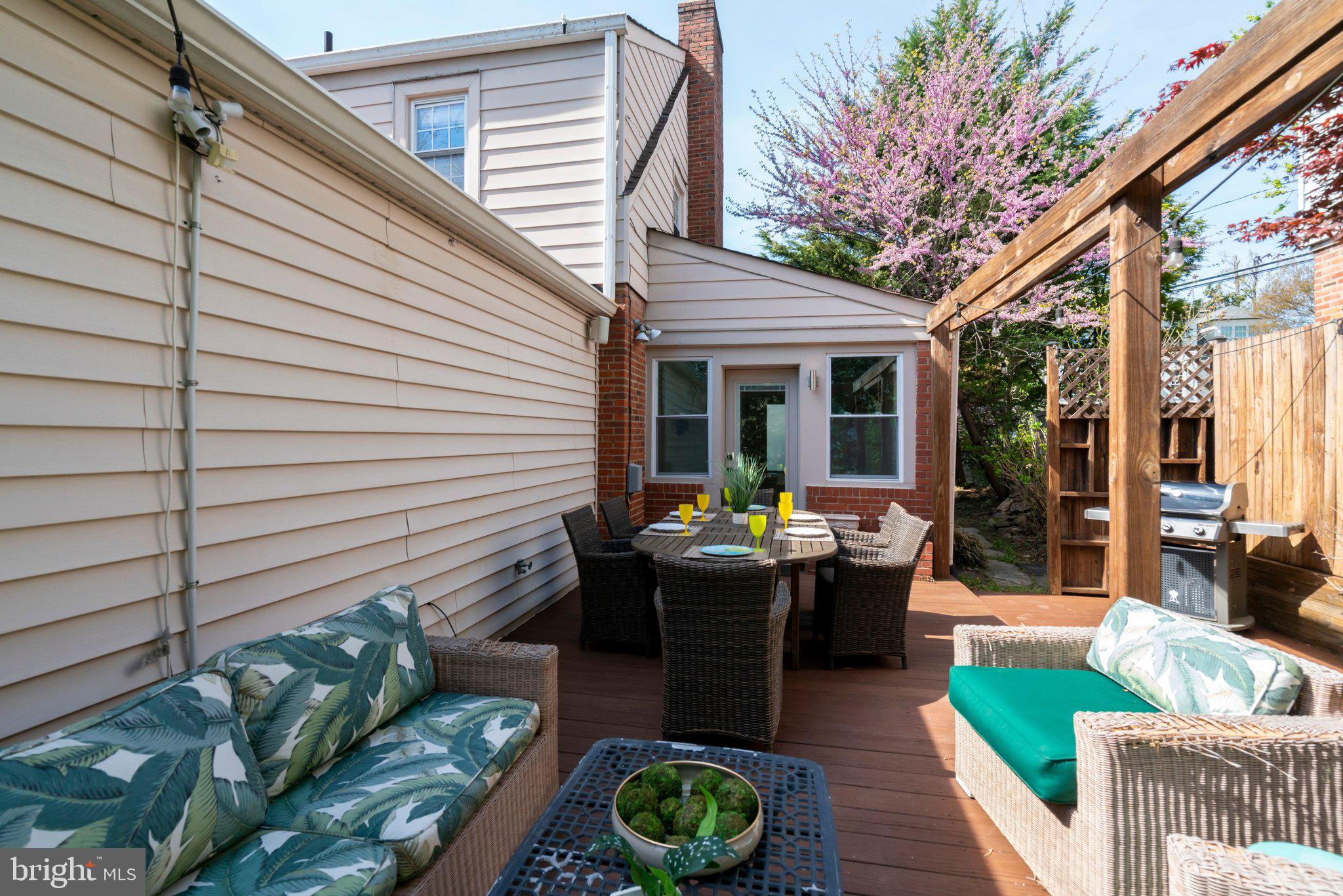4916 26th Street North Arlington, VA 22207 - Photo 38 of 46 a view of a patio with couches table and chairs and potted plants