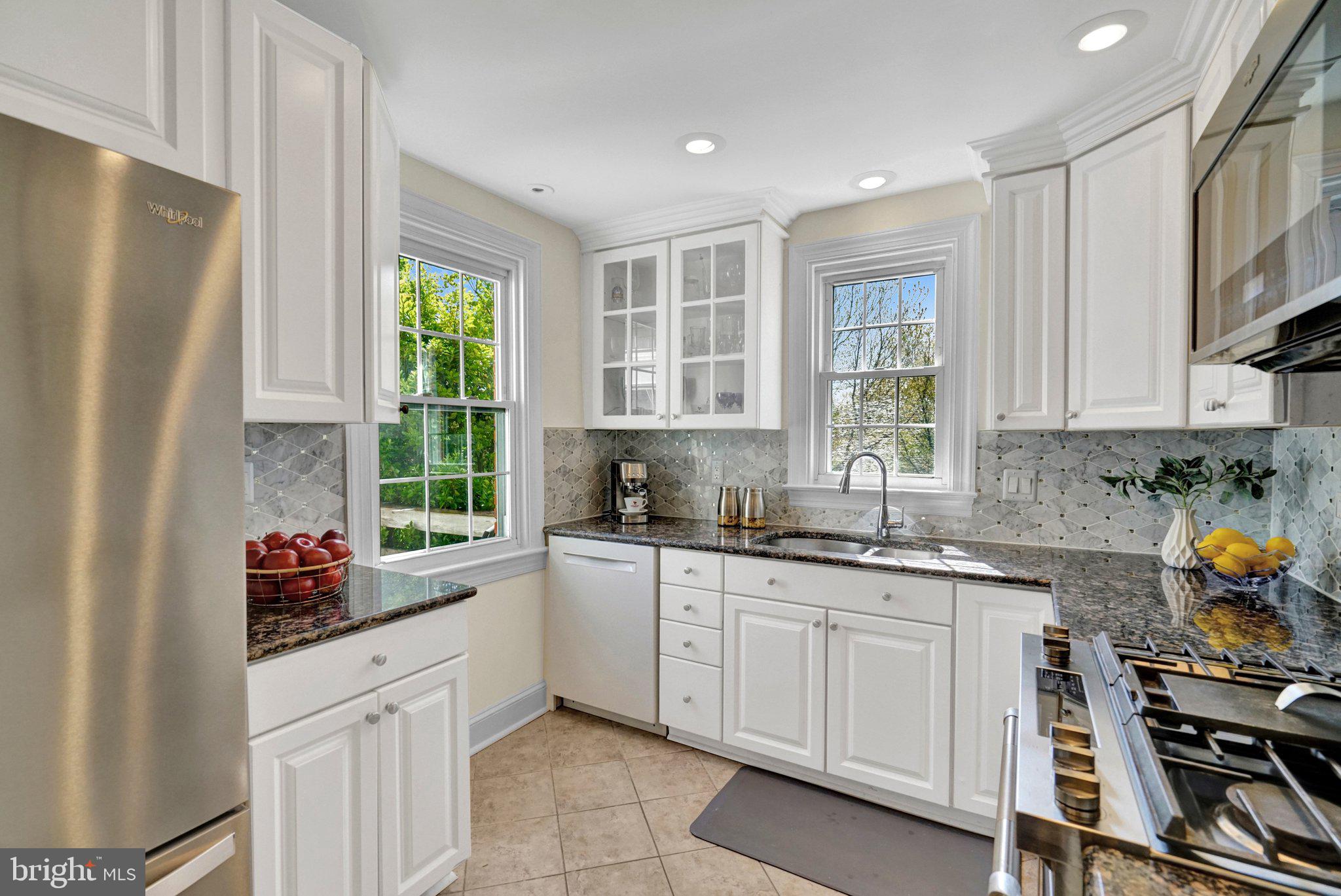 4916 26th Street North Arlington, VA 22207 - Photo 9 of 46 a kitchen with white cabinets and window