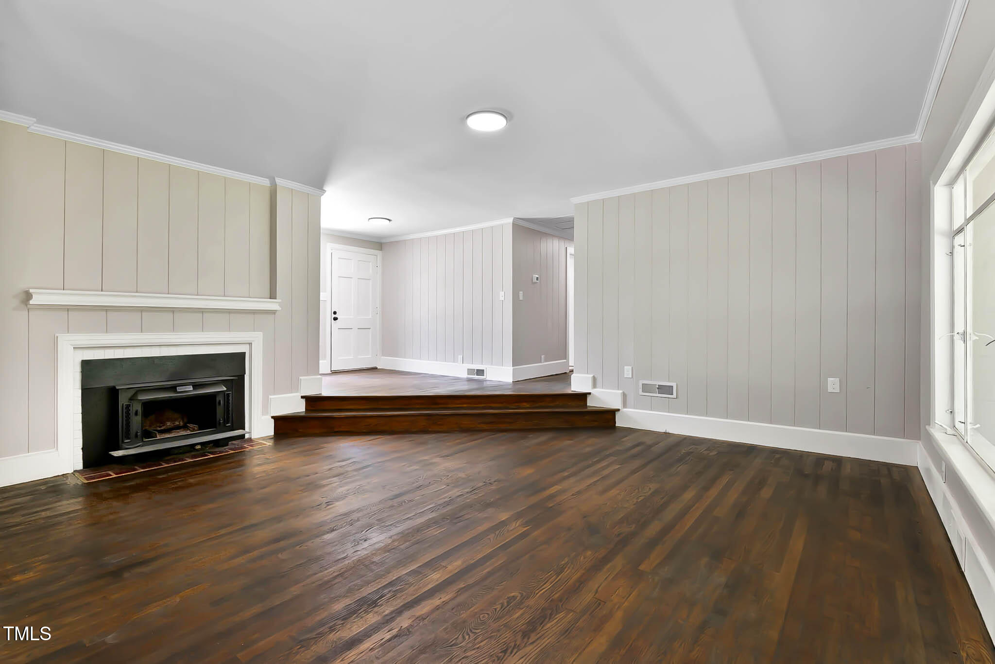 519 West Raleigh Street Siler City, NC 27344 - Photo 25 of 46 a view of empty room with wooden floor and fireplace