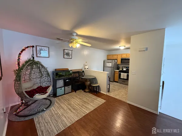 a living room with furniture and a wooden floor