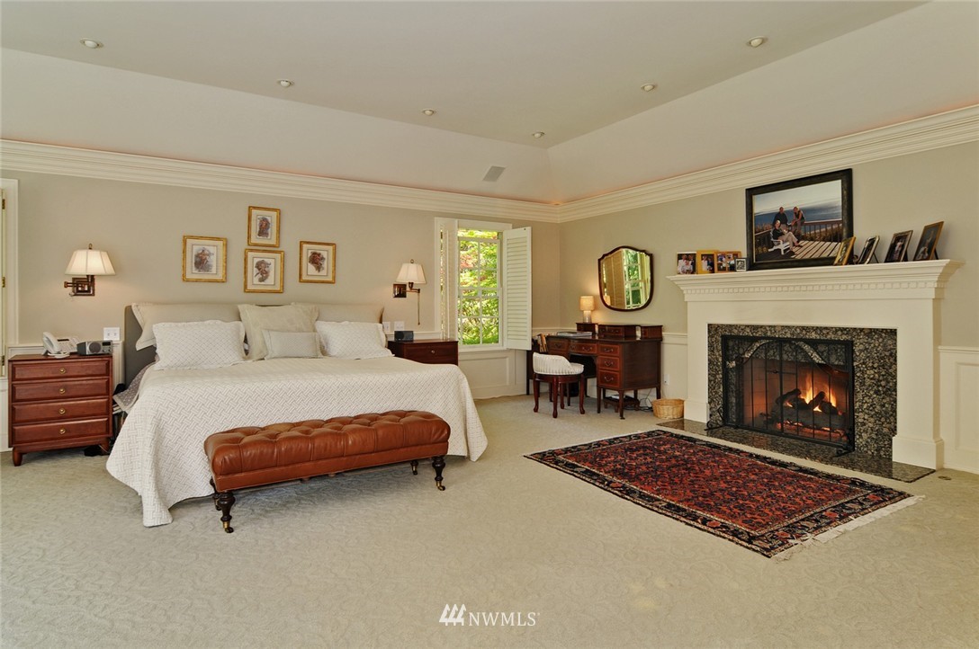 21 Cherry Loop Northwest Shoreline, WA 98177 - Photo 12 of 25 a spacious bedroom with a bed a table and a fireplace