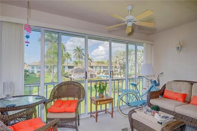 a living room with furniture and a floor to ceiling window