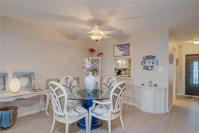 a view of a dining room with furniture and chandelier
