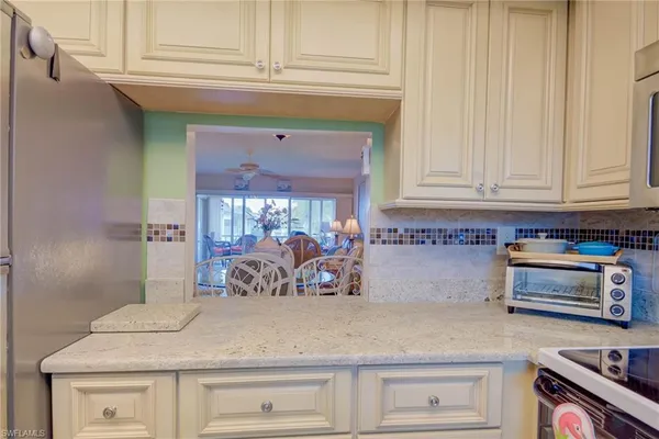 a kitchen with stainless steel appliances granite countertop a sink and cabinets