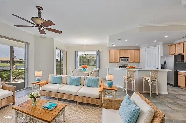 a living room with furniture kitchen view and a large window