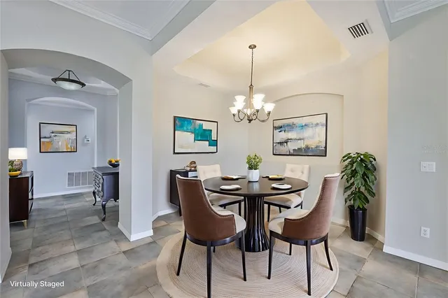 a view of a dining room with furniture and chandelier