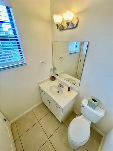 a bathroom with a sink mirror and toilet